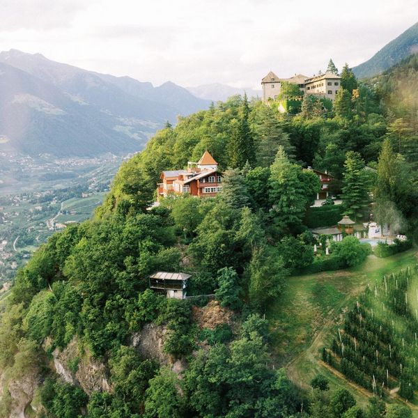 Sat atop a mountain ledge beneath its very own castle and overlooking Merano, Castel Fragsburg...